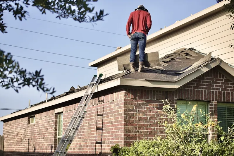 Professional roofer working on a residential roof in Briarwyck